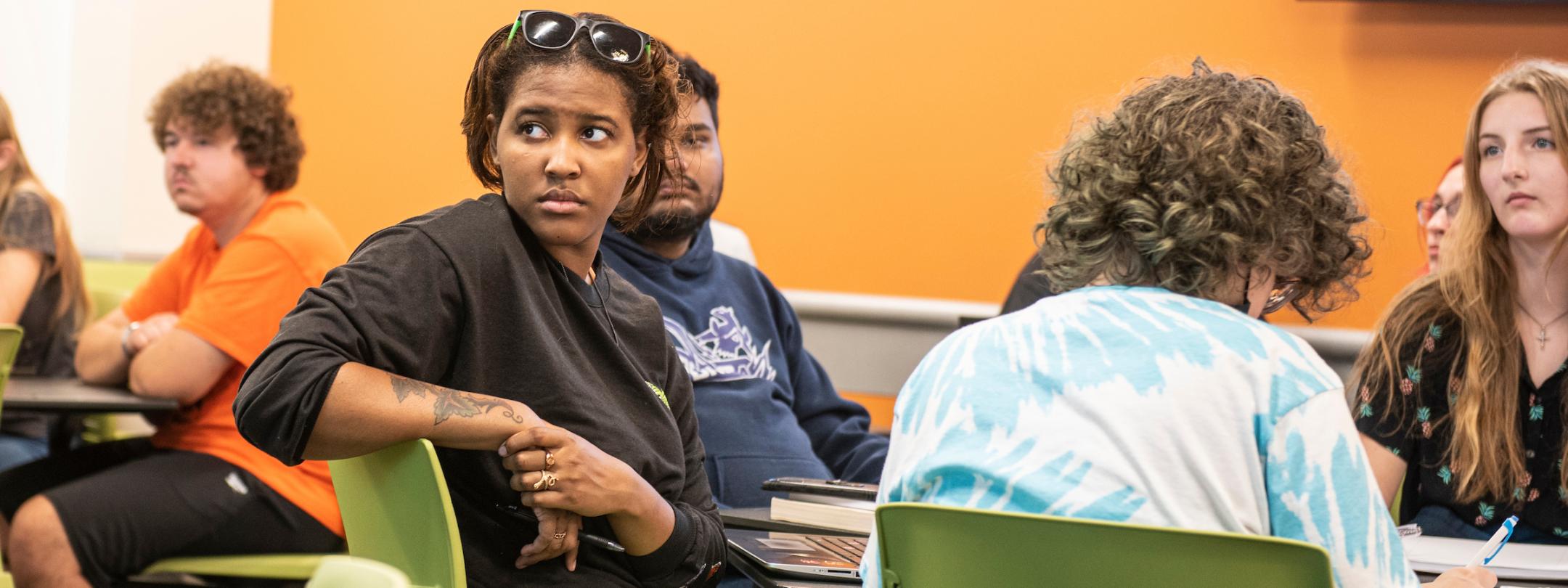 Students listen to a lecture in a COLA classroom.