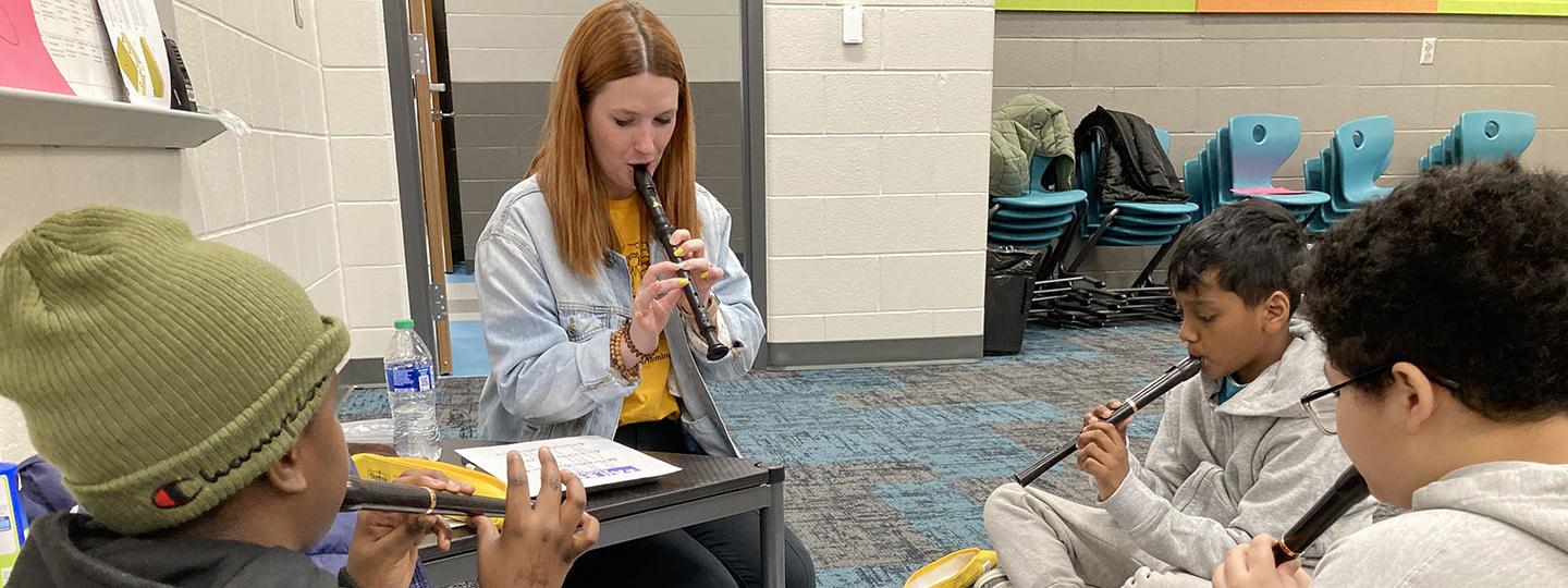 Maddy Urbahns teaching a 5th grade music class to play the recorder.