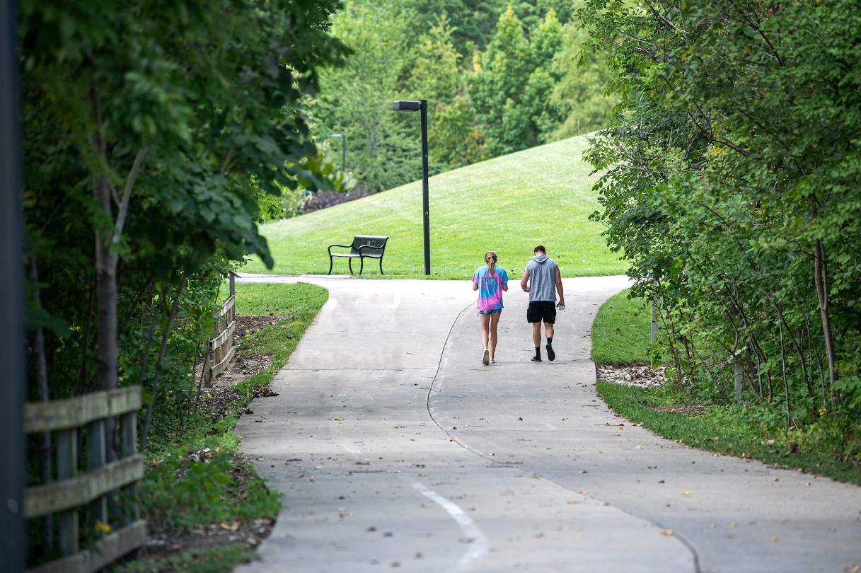 Students walking across campus in the summer.