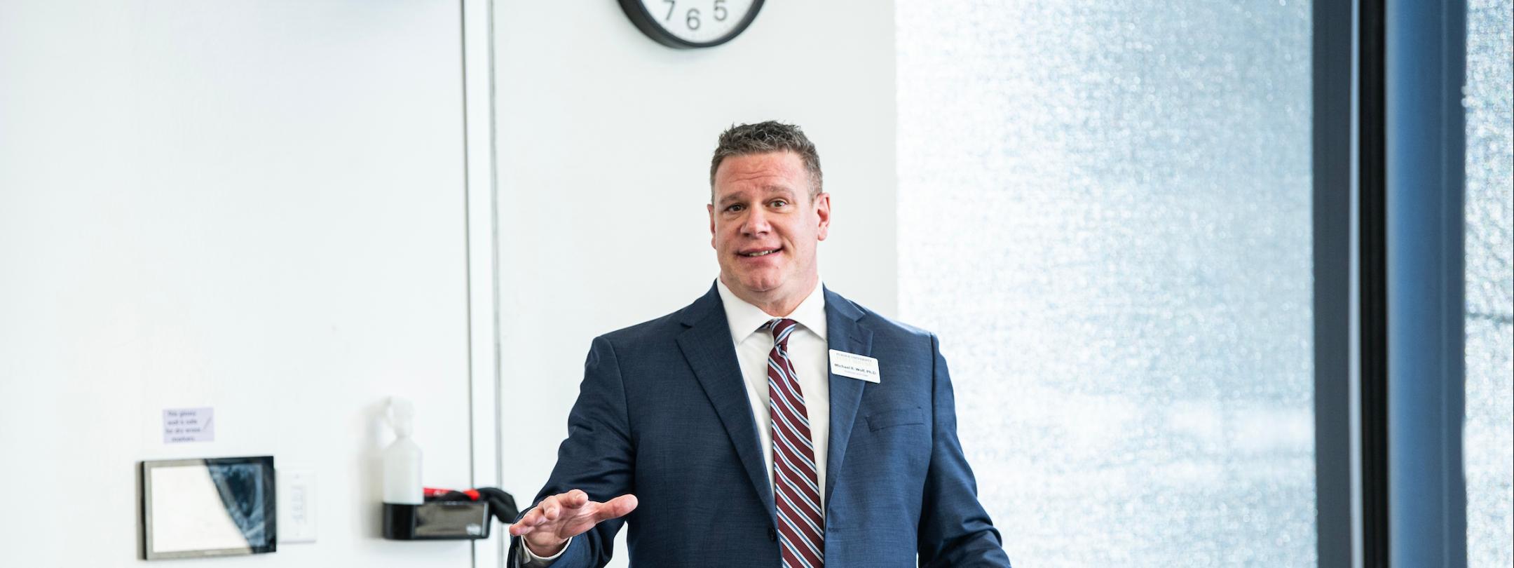 Mike Wolf introduced a guest speaker to the class.