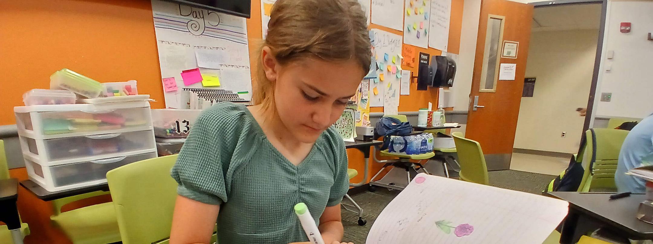 Chloe Hoffman, 11, a sixth grader at Maple Creek Middle School, works on a drawing as part of the Appleseed Writing Project summer camp at PFW.