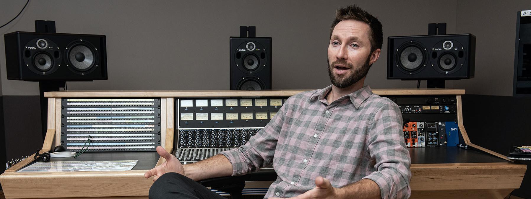 John Buteyn next to a sound board