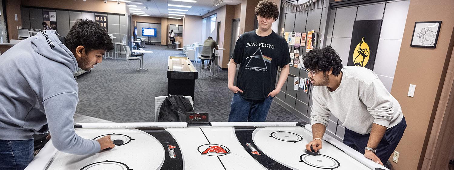 Students are playing air hockey