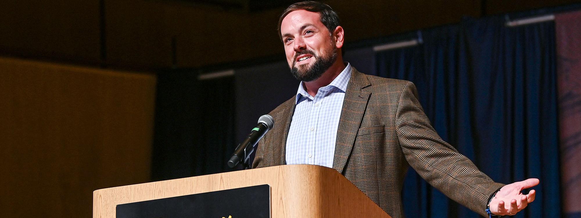 Luke Russert speaking at a lectern