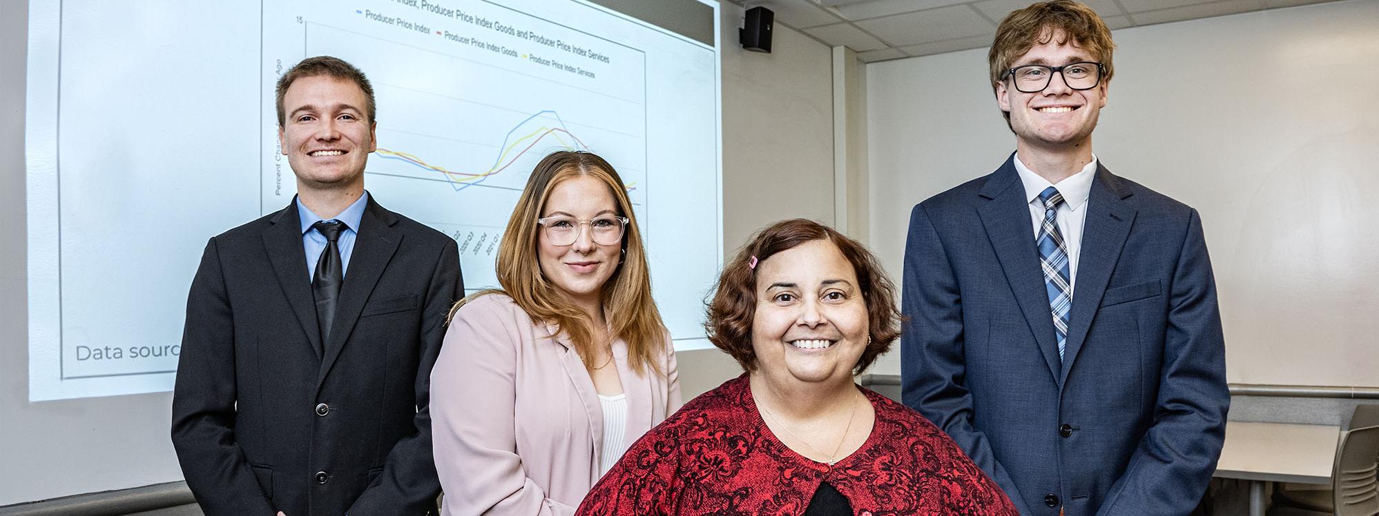 Carson Morton, Pia Briz, Heather Tierney, associate professor of economics, and Josh Fairchild. 