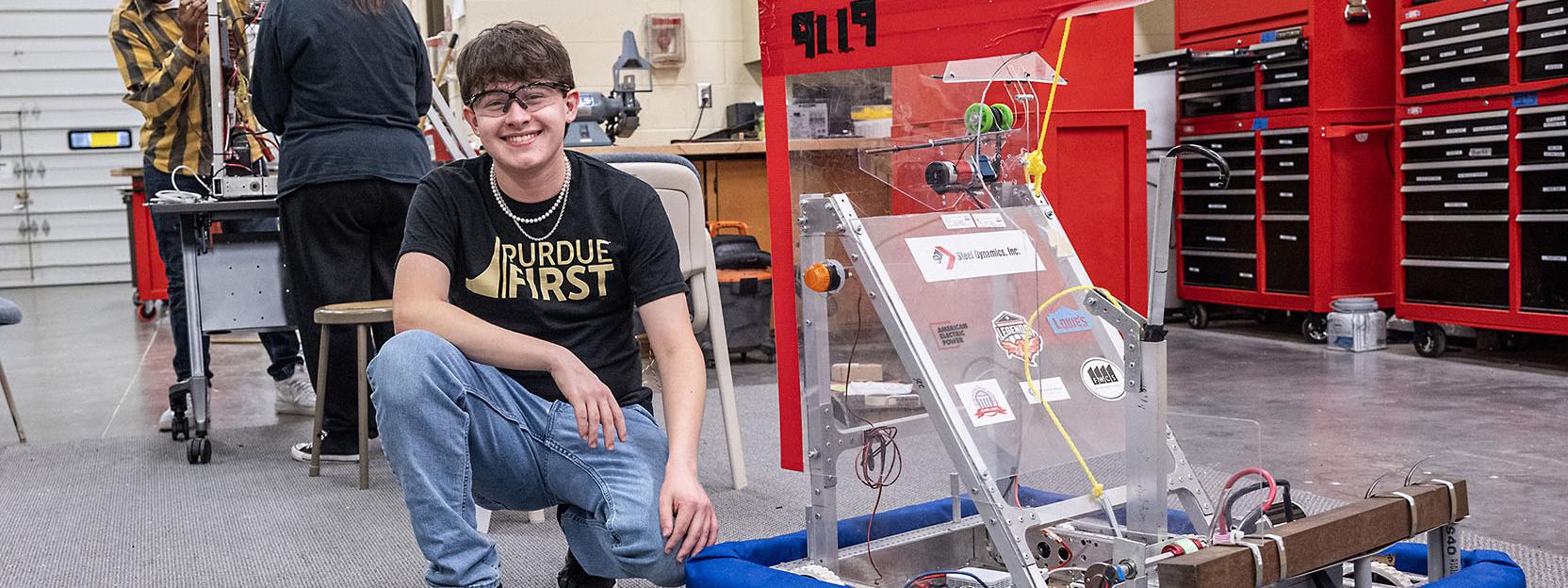 Drew Clem is working with robotics team students