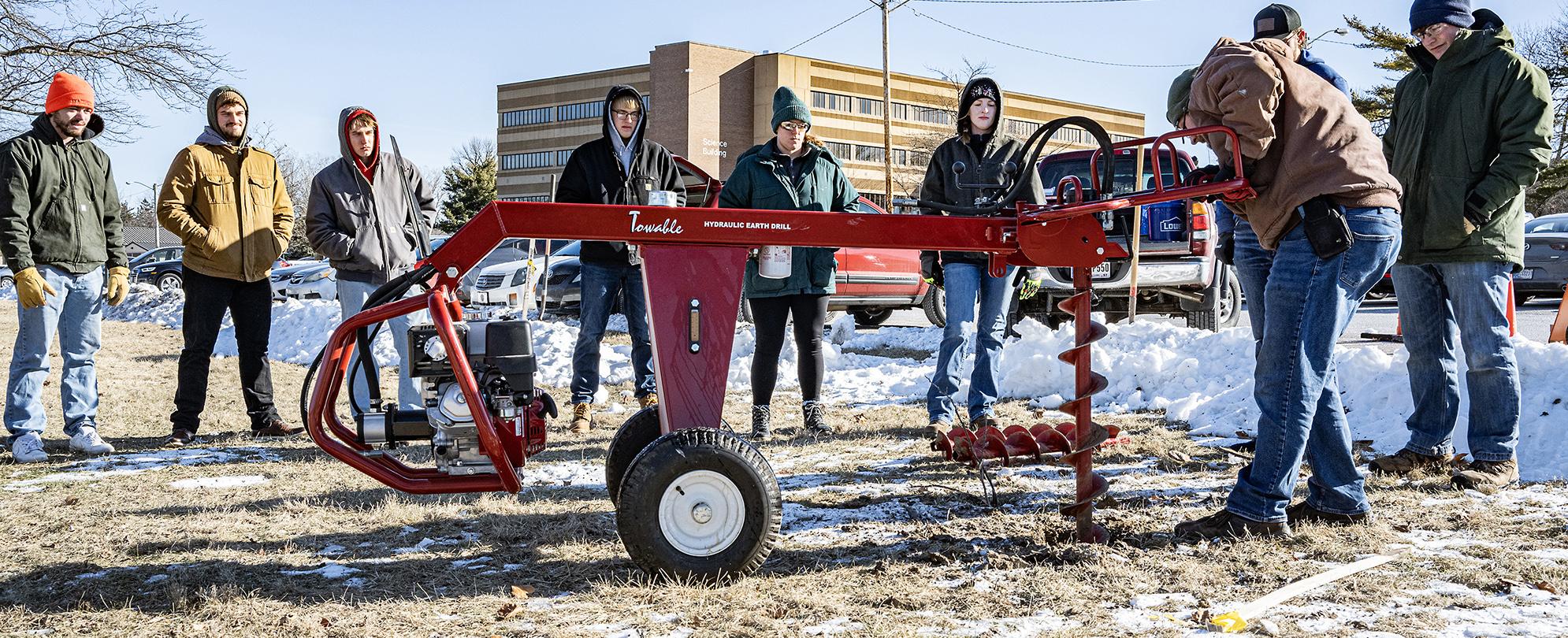 Civil Engineering students testing soil outside.