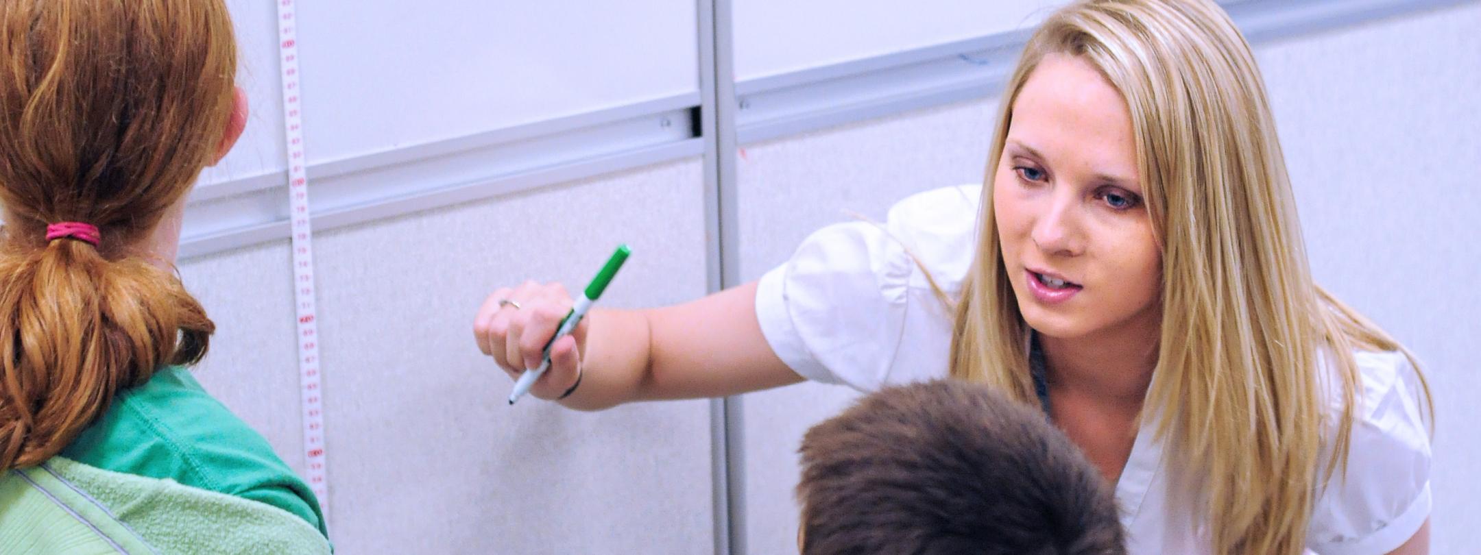 A student teacher at a white board