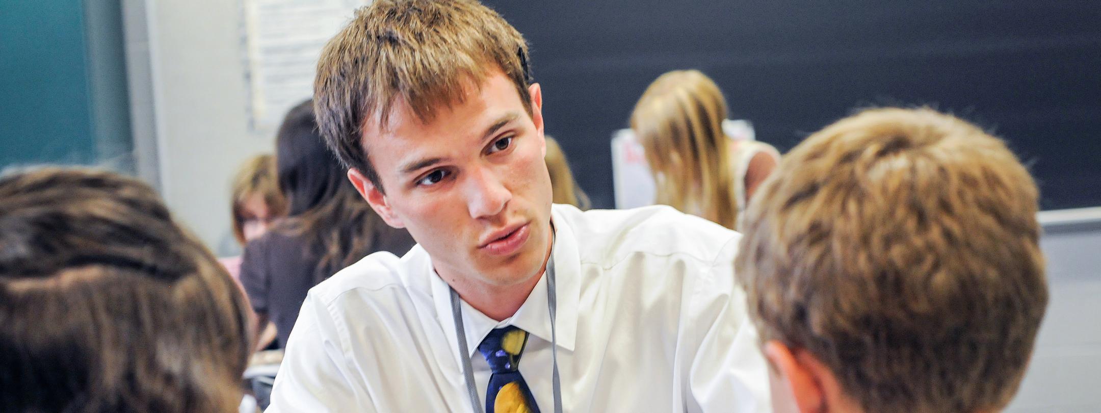 A male student teacher in the classroom