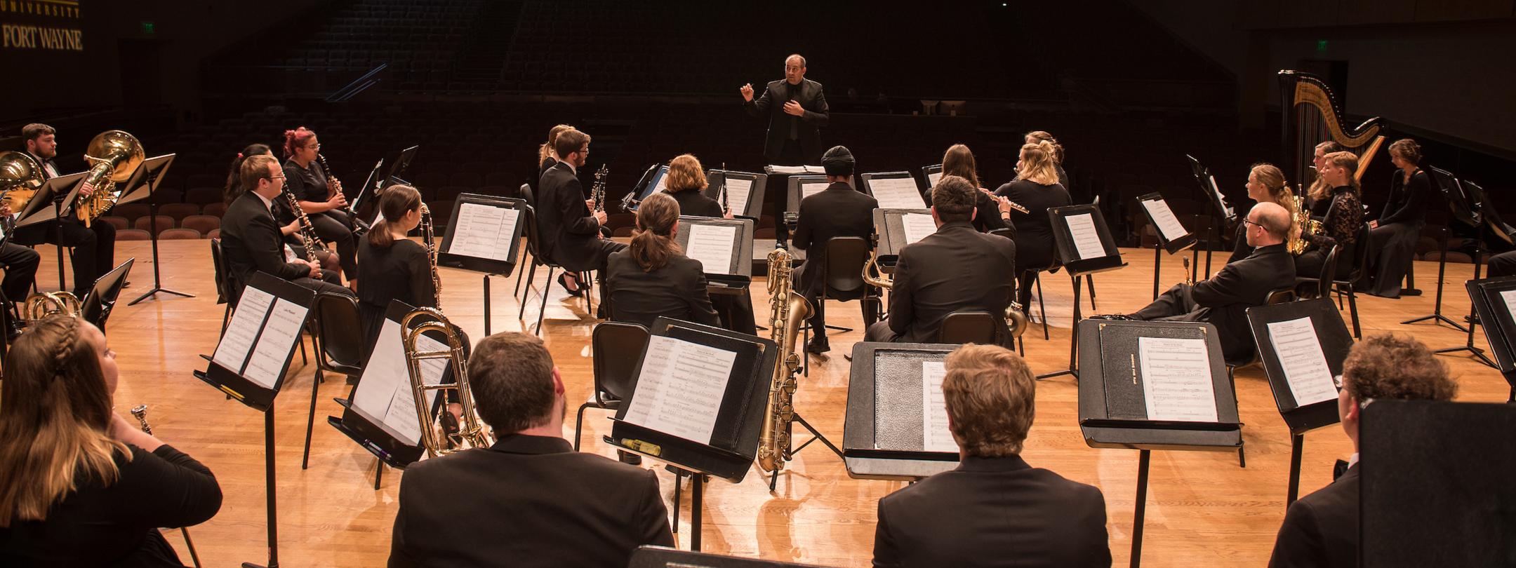 Orchestra students performing a concert.