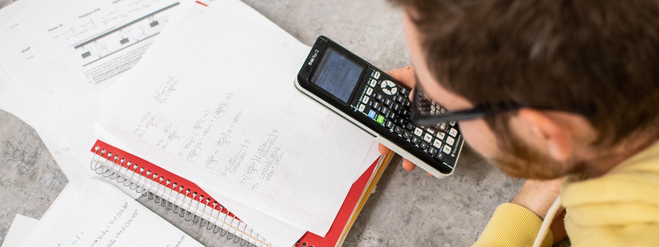 A student with a calculator