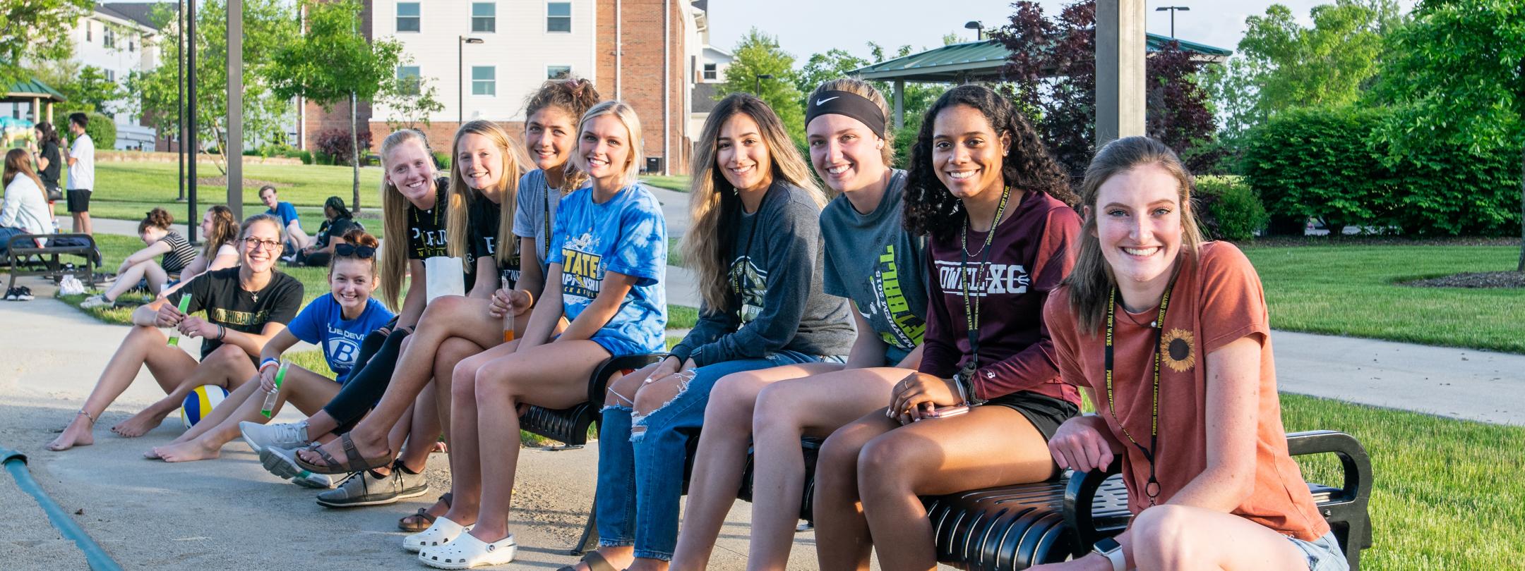 PFW students watching sand volleyball on the Student Housing campus.