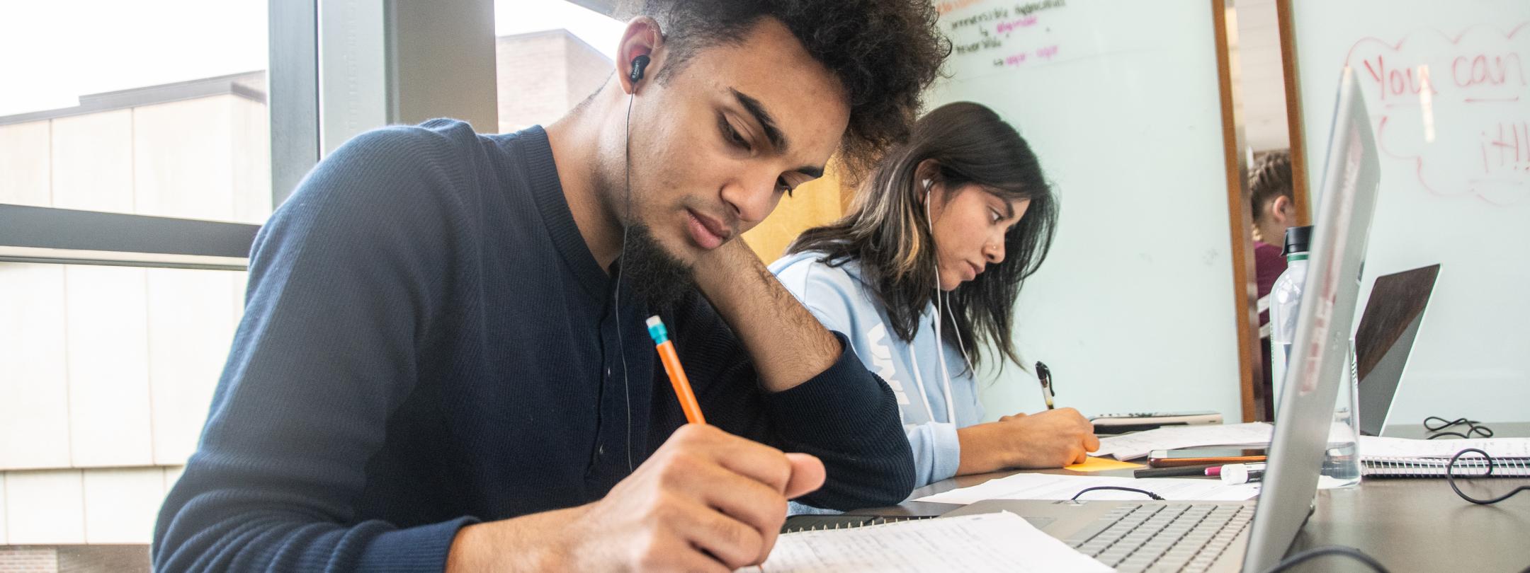 Student studying his class notes.