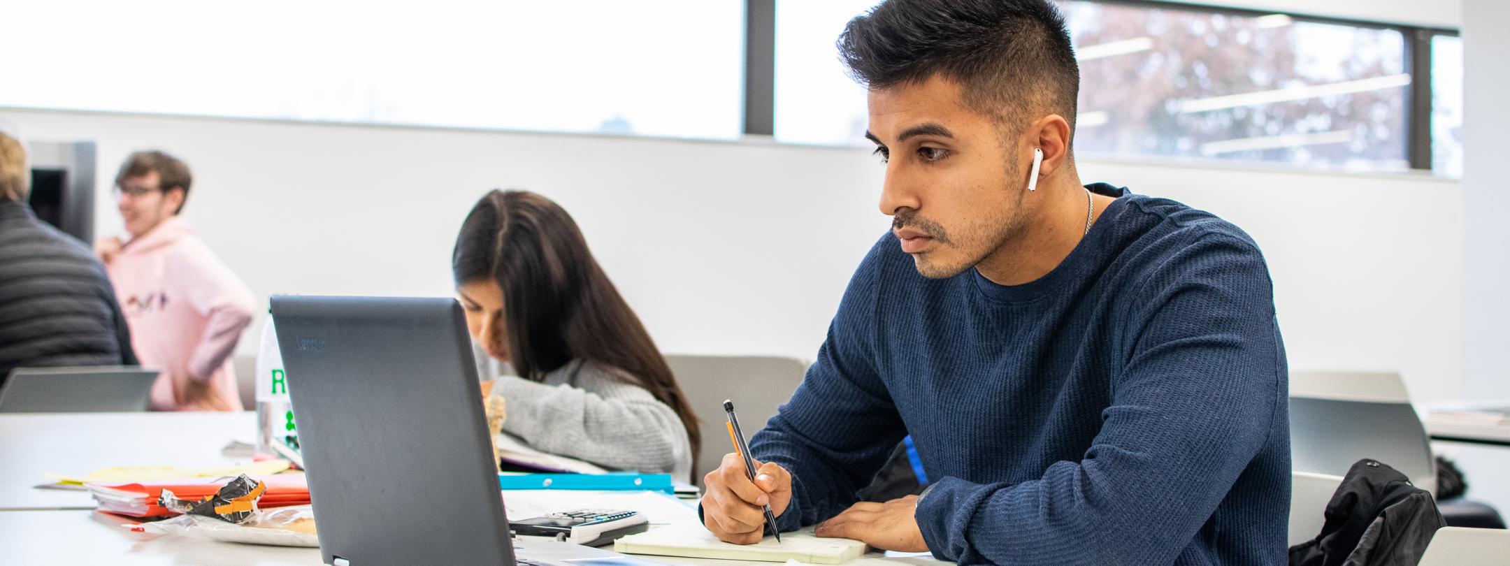 Student studying his class notes.