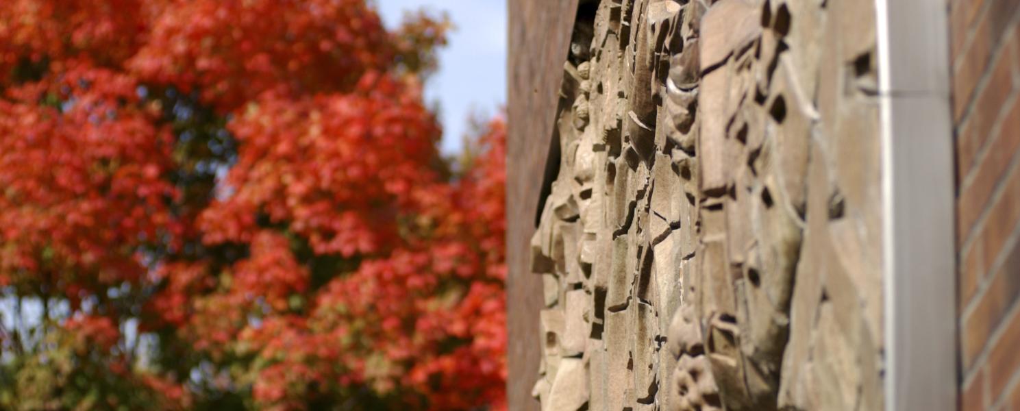 The sculpture named Indiana Landscape is displayed on the building's outside wall of Neff Hall.