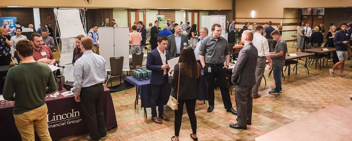 Students collecting information on careers at an accounting event on campus.