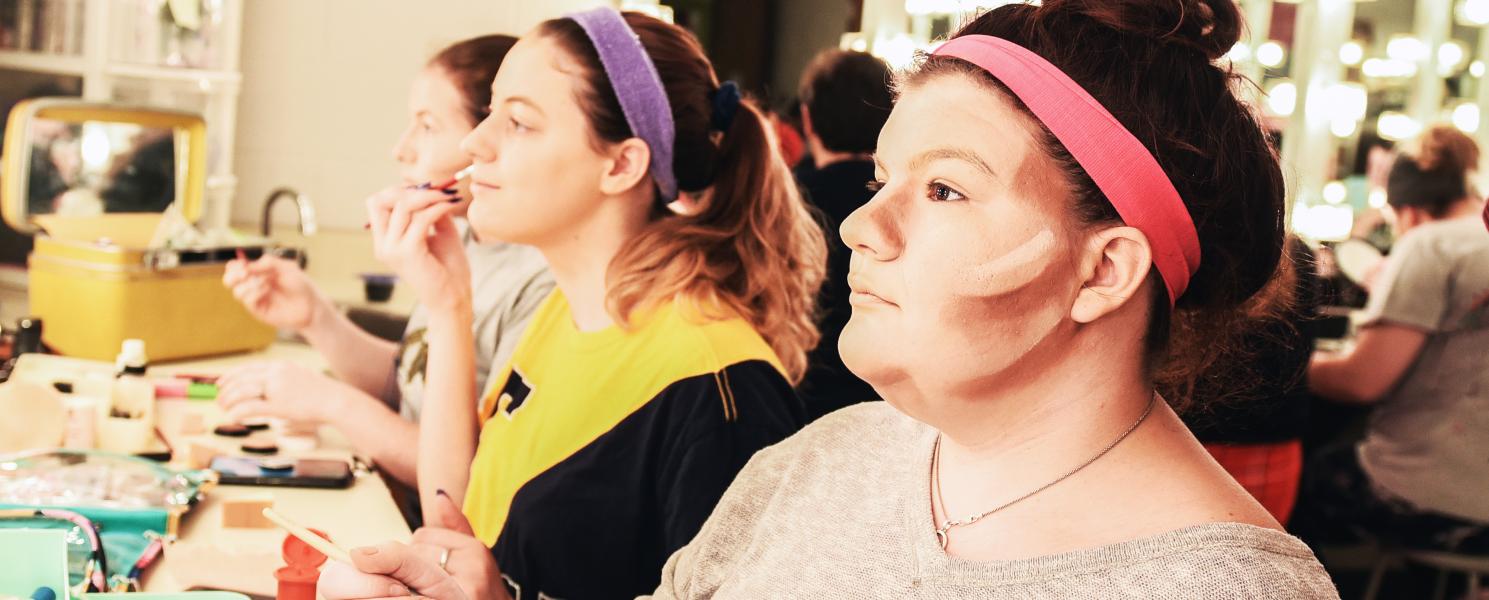 Students put on makeup backstage at Williams theatre