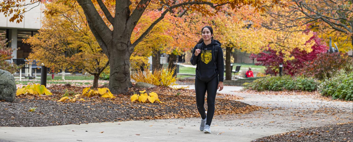 Student walking to class on an autumn day.