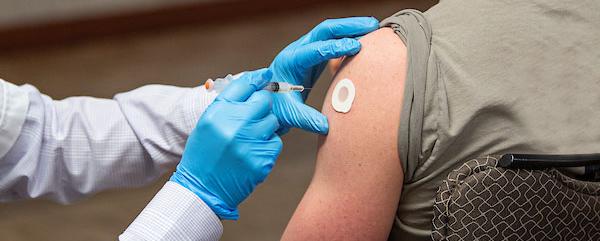 A shot is being administered at a COVID-19 vaccination clinic at Purdue Fort Wayne