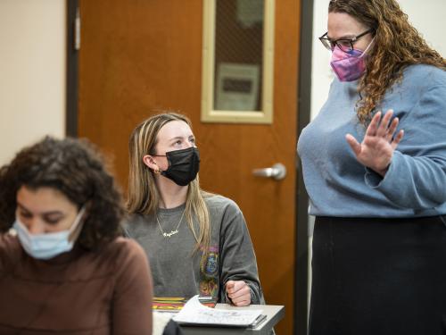 A student working on a collage in a gender studies class