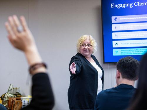 Professor Nancy Jackson teaches music therapy students in a classroom setting.