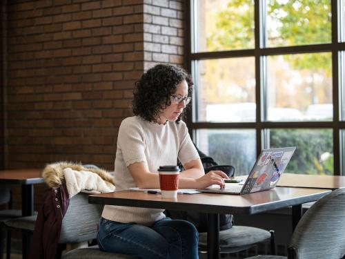 A student works on a laptop.