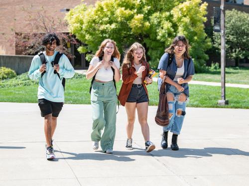 Students walk across campus together.