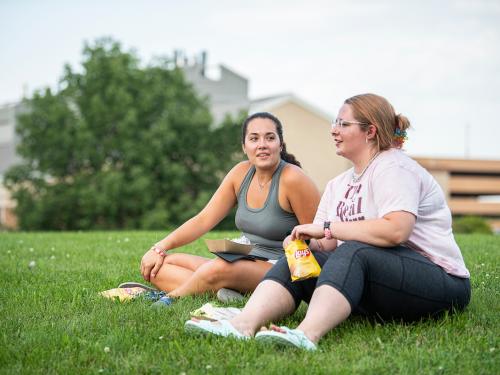 Students talking during a campus kickoff BBQ.