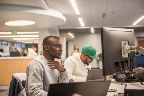 Student using a computer in the library to contact ITS.