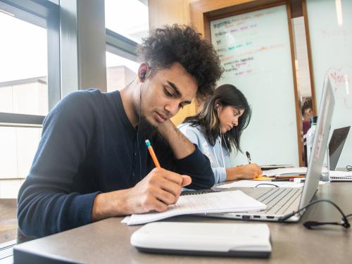 Student studying his class notes.