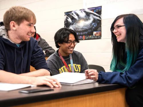 Physics students reviewing lab notes.