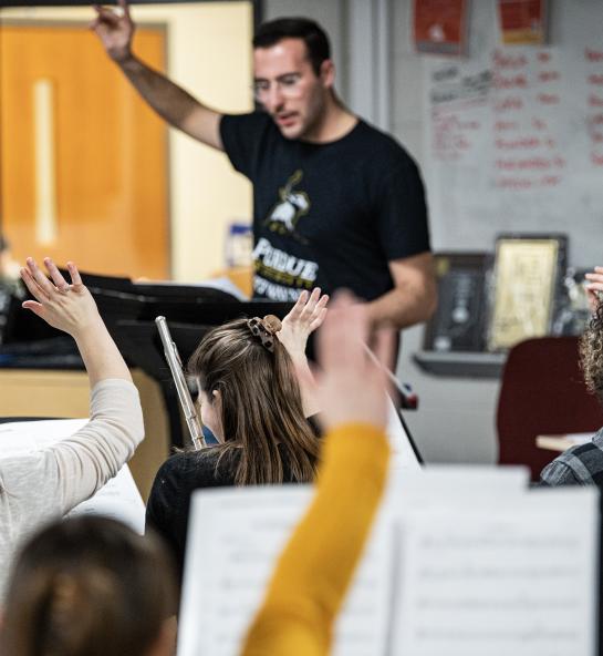 Senior music education student Ethan Hacker conducts the Fusion Band.