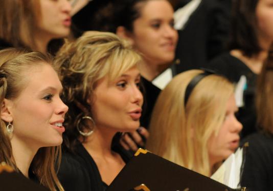 close up picture of women singing 