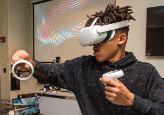 student playing with a VR headset