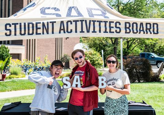 Students hold up letters for SAB.