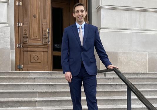 Ben Bailey on the steps of a courthouse