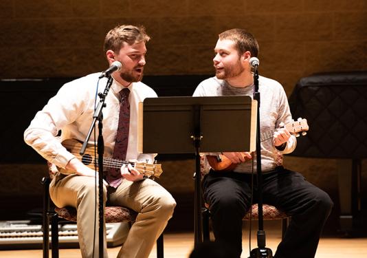 two men playing ukulele