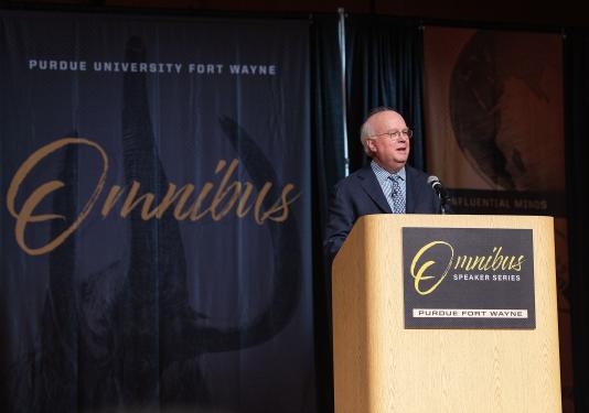 Karl Rove is speaking to the audience in Auer Performance Hall
