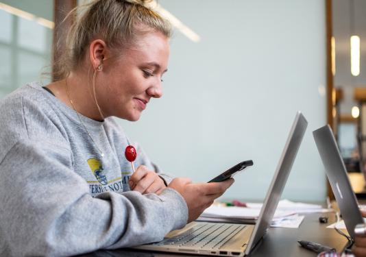 Student looking at her cell phone.