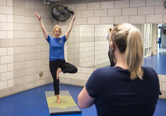 Employee health coach Lindsay Bloom leads a yoga class