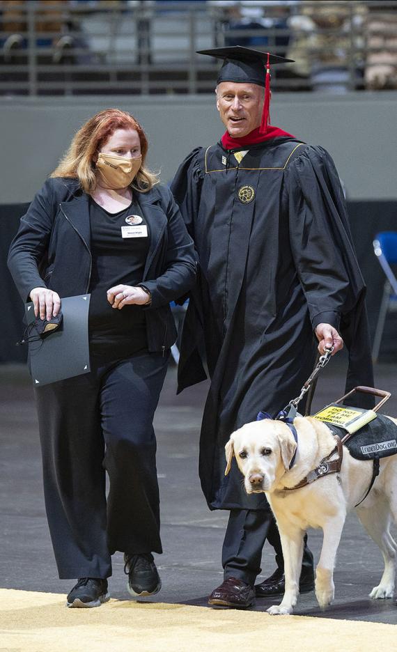 Jim Platzer and his leader dog, Maggie, at the 2021 commencement ceremony