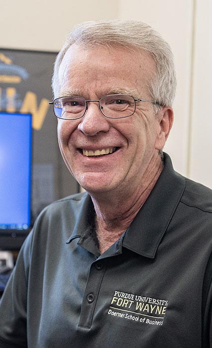 Mike Slaubaugh is sitting in front of his computer