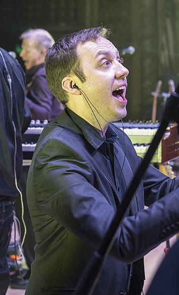 William Sauerland leads the choir at a Pink Droyd concert in the Embassy Theatre.