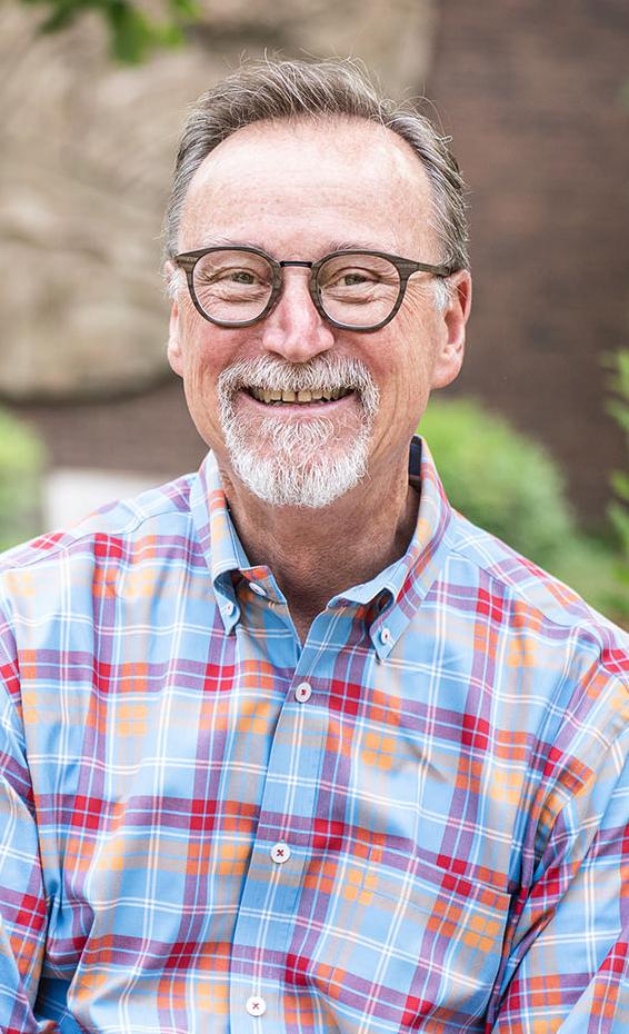 Portrait of Wylie Sirk in front of Neff Hall.