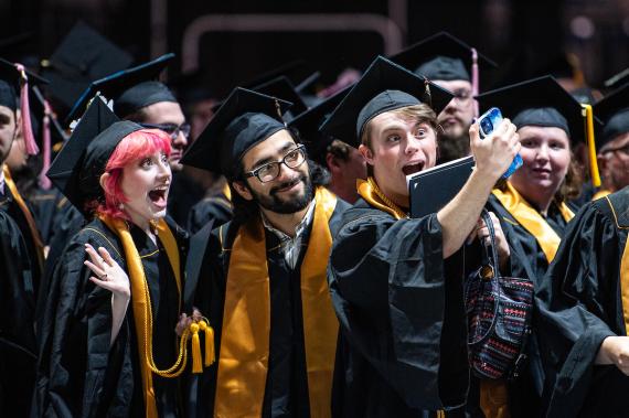 Students take a selfie on commencement day.