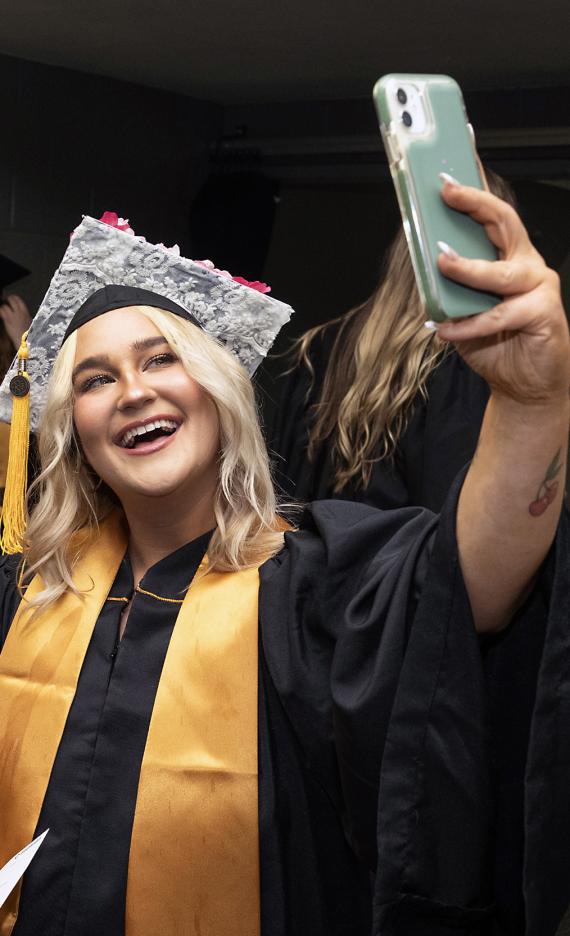 Graduating students take a selfie together.