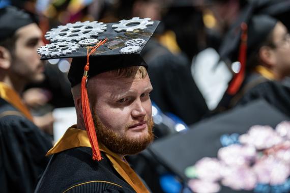 ETCS graduating student with gears decorating the cap.