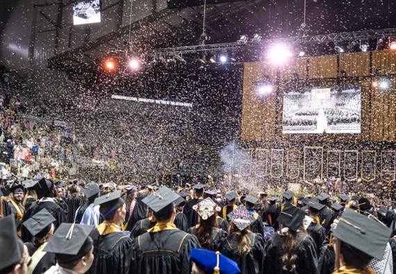 Students cheer as the confetti is released.