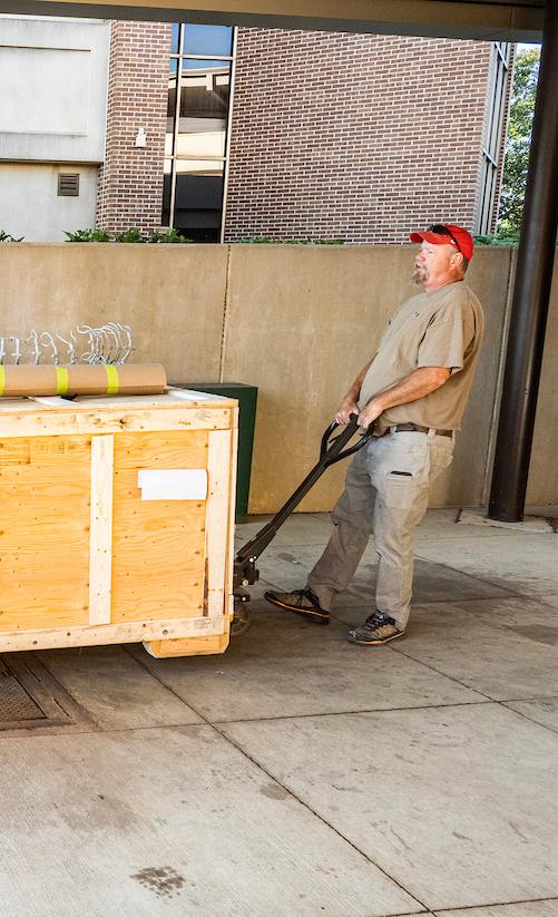 Mike Thom of Trenton, Ontario’s Research Casting International, right, and Garth Dallman, begin unloading the mastodon bones on Monday morning, Aug. 12.