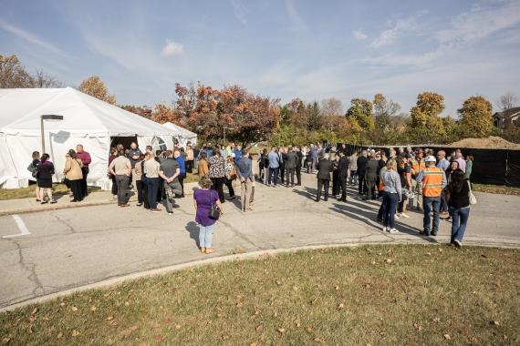 Trace groundbreaking crowd.